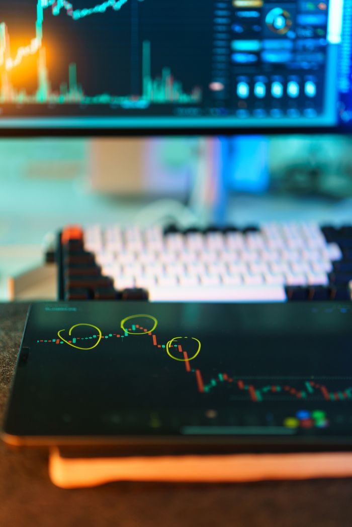 Home Visual of cryptocurrency trading screens displaying market analysis and candlestick charts.